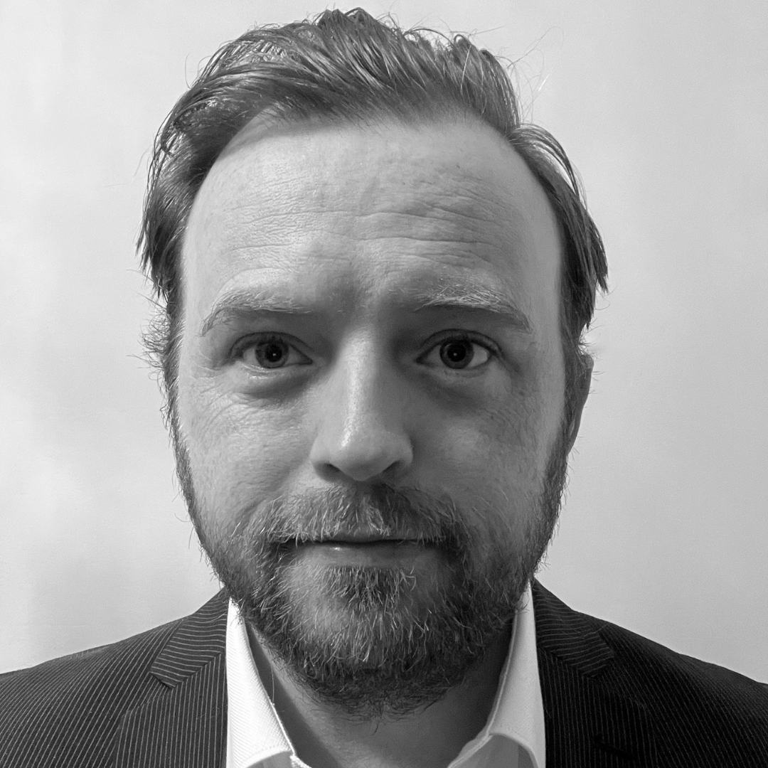 Black and White portrait of Irish male in dark suit with short hair and beard
